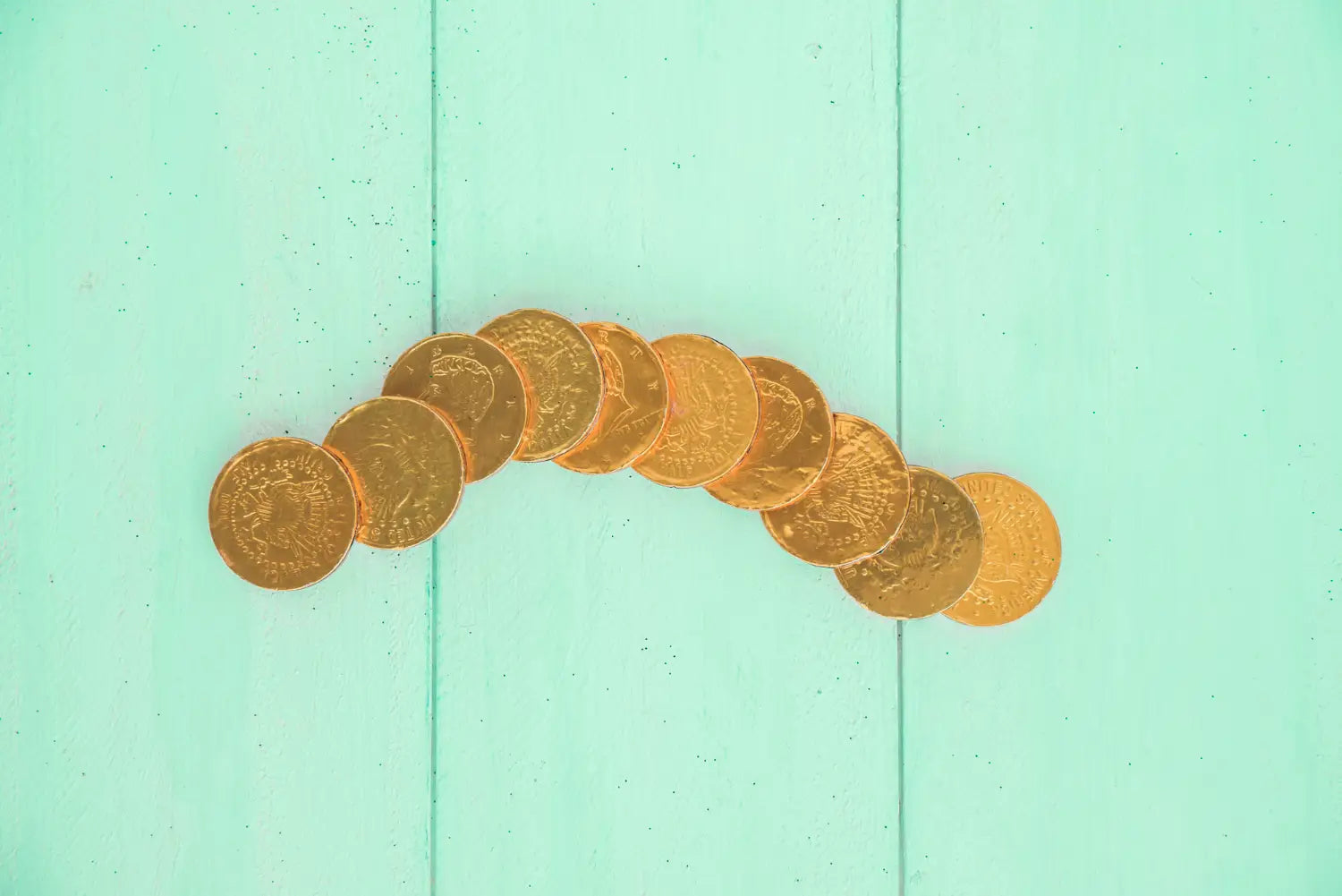 Set of gold coins on board for selling 